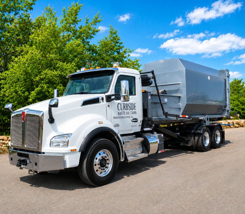 Phoenix Dumpster Rental Company Truck Hauling Trash Compactor in Phoenix